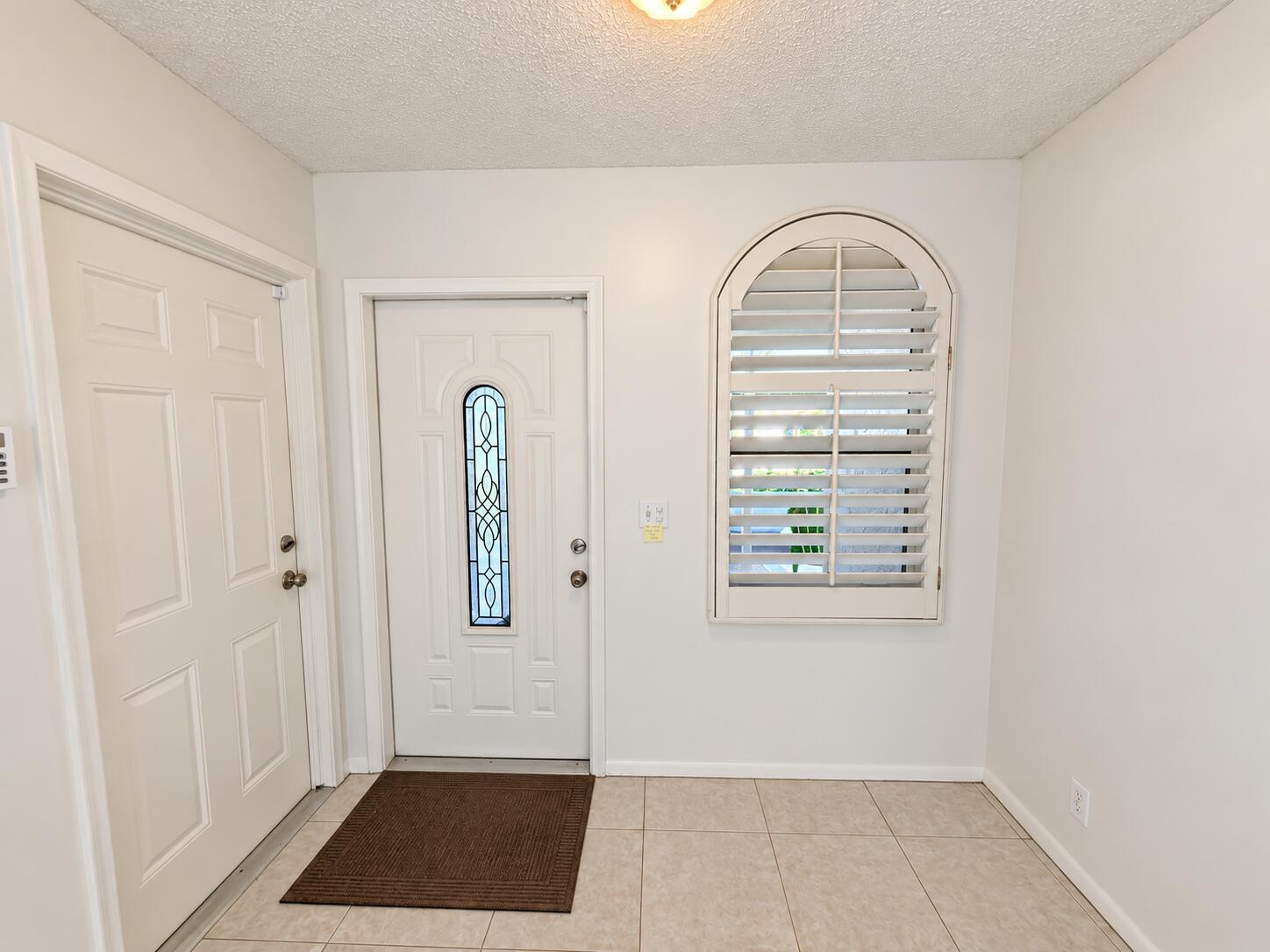 6309 Dusenburg Road Delray Beach, FL 33484 - Photo 4 of 26 Brightened front entry, faithfully prese