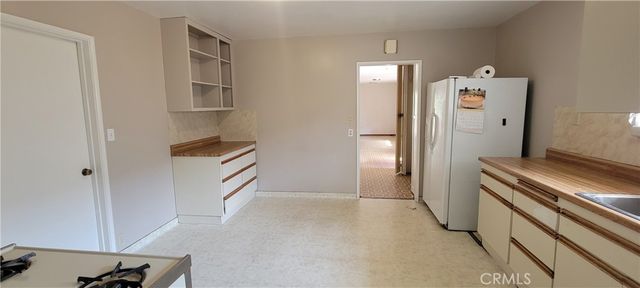 a room with a cabinets and a stove top oven