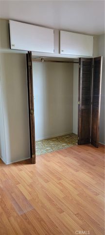 a view of a room with wooden floor and window