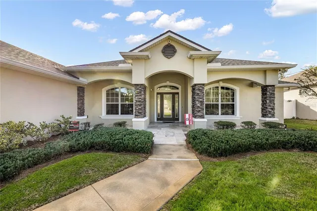 a front view of a house with garden