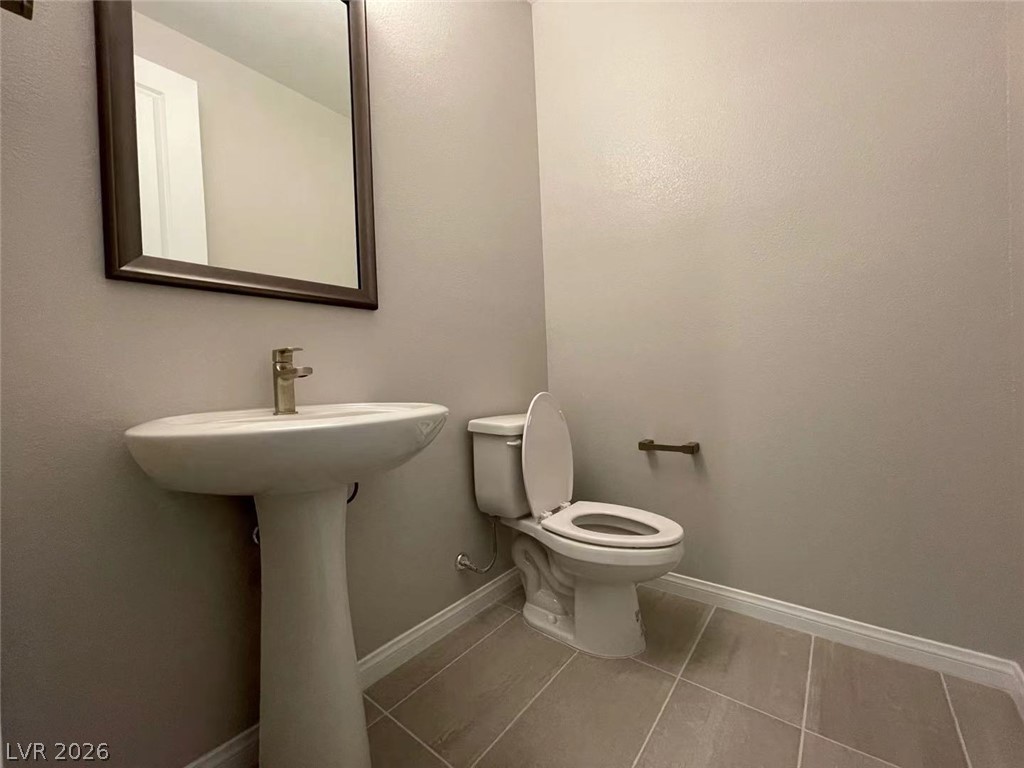 11 Rancho Maria Street Las Vegas, NV 89148 - Photo 11 of 27 A classic pedestal sink paired with neutral tile flooring defines this tidy powder room.
