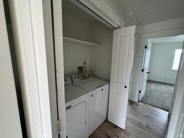 608 South 500 West, Unit 3 Provo, UT 84601 - Photo 21 of 35 Dedicated laundry area featuring a white top-load washer and dryer set, an overhead storage shelf, and plank-style flooring