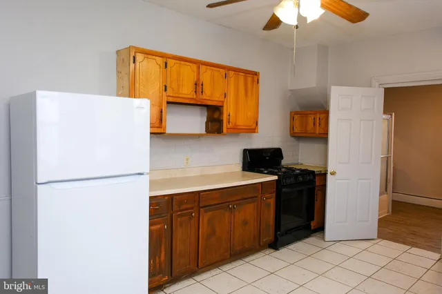 a kitchen with a refrigerator and a stove