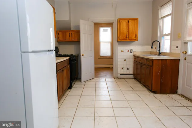 a kitchen with a sink a stove and a refrigerator