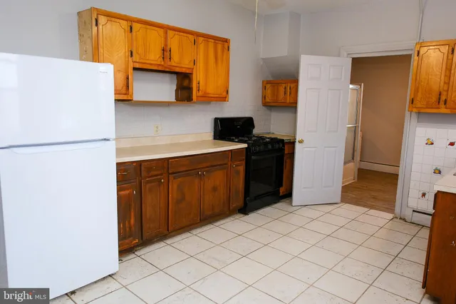 a kitchen with a refrigerator and a stove