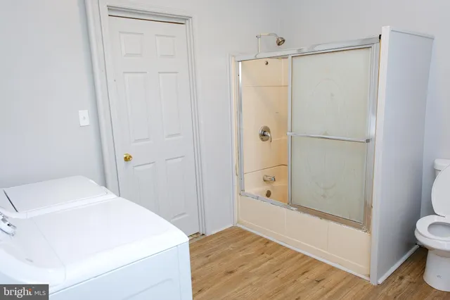 a bathroom with a shower and a toilet