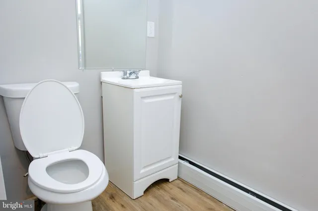 a bathroom with a toilet sink and mirror