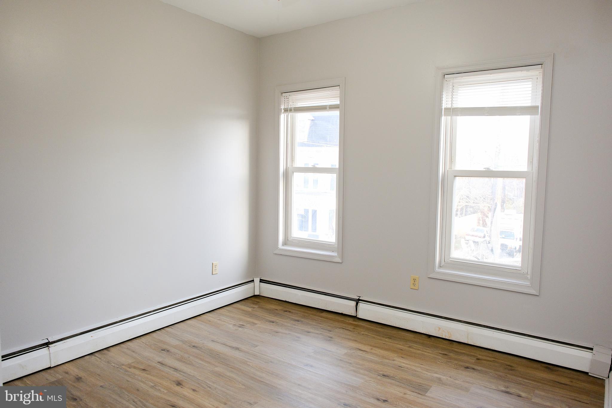 225 Front Street York, PA 17404 - Photo 28 of 42 an empty room with wooden floor and windows