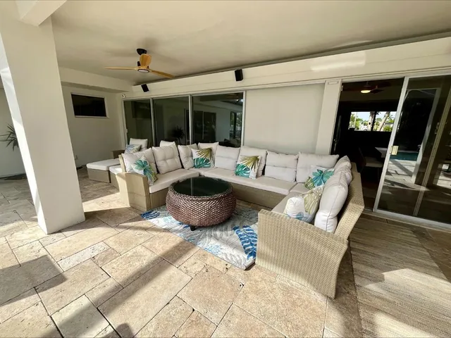 a living room with furniture and large windows