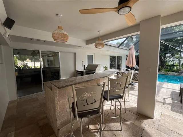 a kitchen with stainless steel appliances granite countertop a sink and a refrigerator