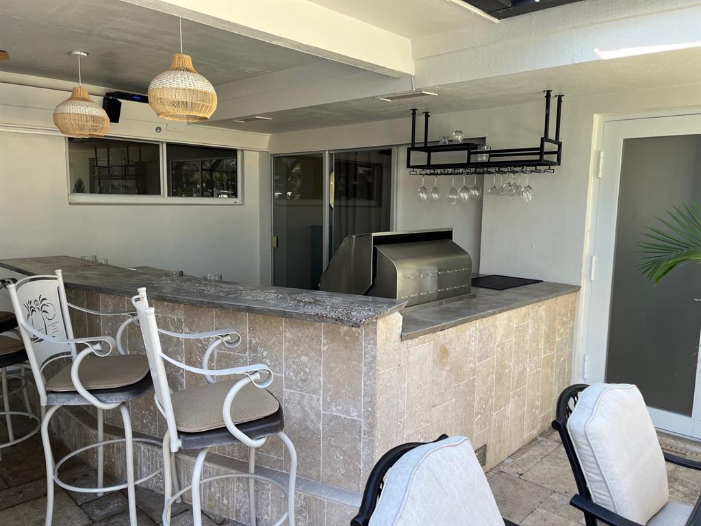 556 Southeast 15th Avenue Deerfield Beach, FL 33441 - Photo 14 of 42 a kitchen with stainless steel appliances granite countertop a sink and a refrigerator