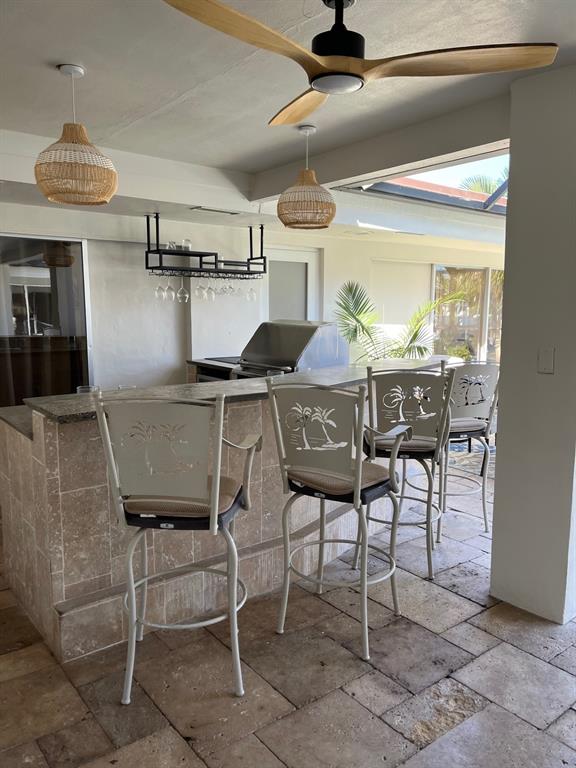556 Southeast 15th Avenue Deerfield Beach, FL 33441 - Photo 15 of 42 a view of a dining room with furniture and a chandelier