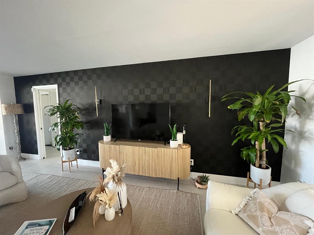 556 Southeast 15th Avenue Deerfield Beach, FL 33441 - Photo 17 of 42 a living room with furniture potted plant and a flat screen tv
