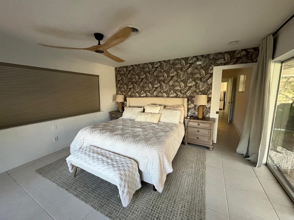 556 Southeast 15th Avenue Deerfield Beach, FL 33441 - Photo 25 of 42 a bedroom with a bed and a large mirror