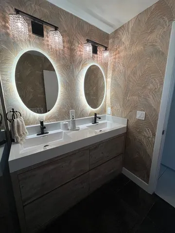 a bathroom with a double vanity sink and a mirror