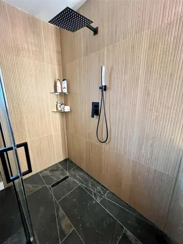 a spacious bedroom with a bed and a ceiling fan