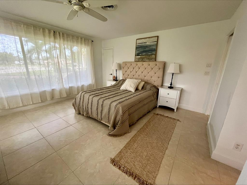 556 Southeast 15th Avenue Deerfield Beach, FL 33441 - Photo 30 of 42 a spacious bedroom with a bed and window