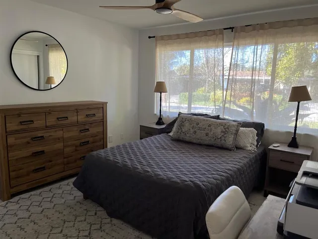 a bathroom with a sink and mirror with bathtub