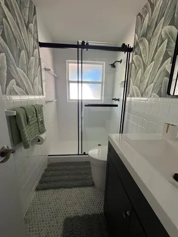 a spacious bedroom with a bed and wooden floor