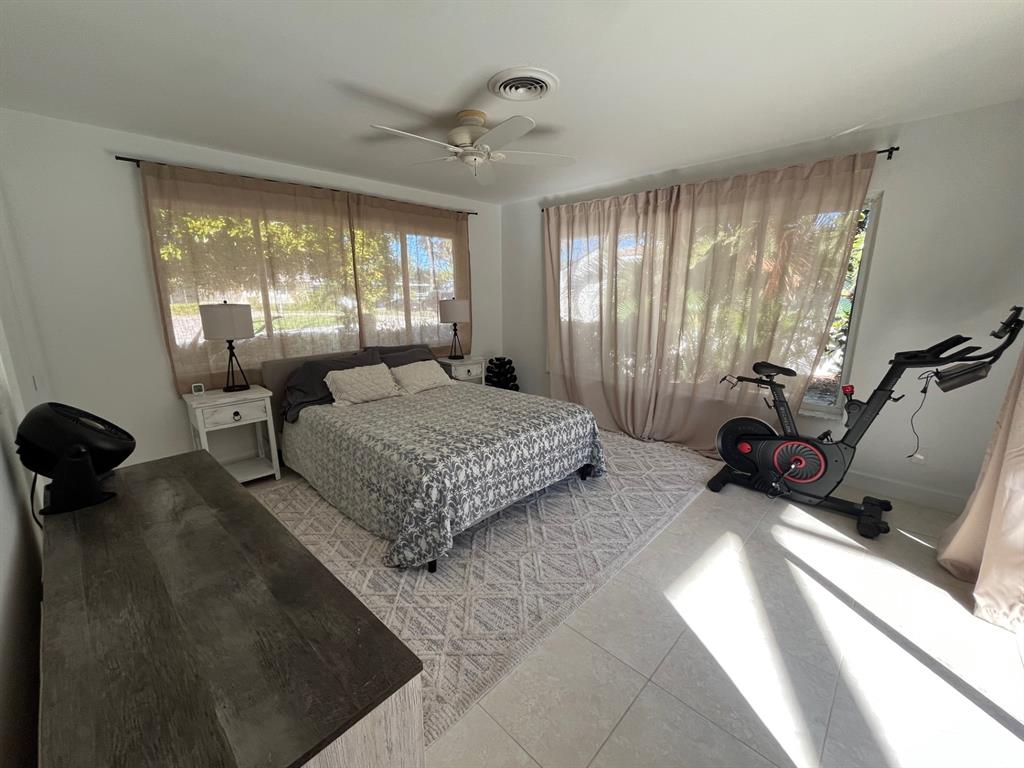 556 Southeast 15th Avenue Deerfield Beach, FL 33441 - Photo 38 of 42 a spacious bedroom with a bed and wooden floor