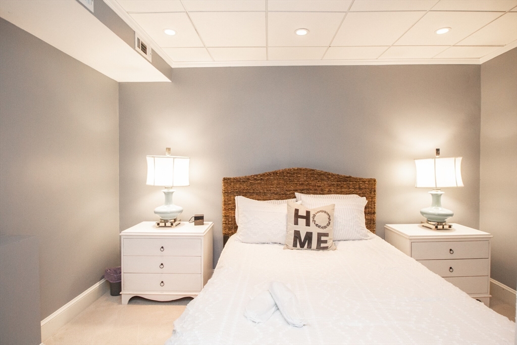 1253 Beacon Street, Unit 4BB Brookline, MA 02446 - Photo 13 of 18 a bedroom with a bed and a night stand