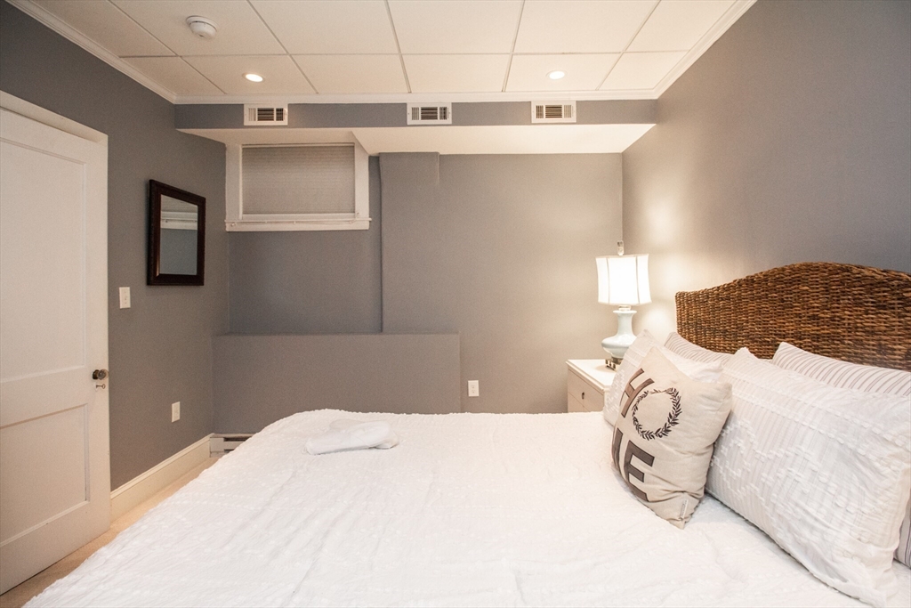 1253 Beacon Street, Unit 4BB Brookline, MA 02446 - Photo 16 of 18 a bedroom with a bed and a window