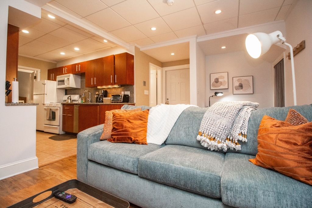 1253 Beacon Street, Unit 4BB Brookline, MA 02446 - Photo 4 of 18 a living room with furniture and kitchen view