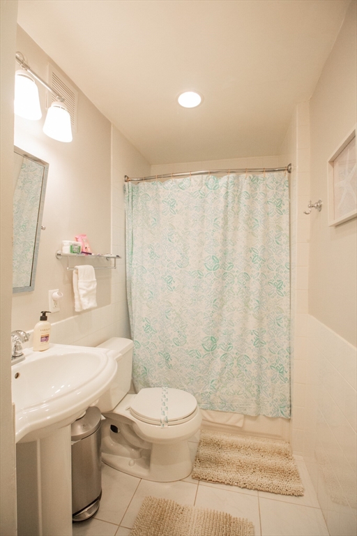 1253 Beacon Street, Unit 4BB Brookline, MA 02446 - Photo 7 of 18 a bathroom with a sink a toilet and shower