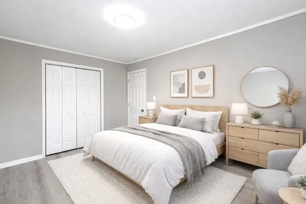 a bedroom with a bed mirror and window