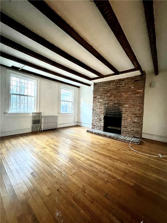 159 Bond Street Brooklyn, NY 11217 - Photo 13 of 20 an empty room with wooden floor and fireplace