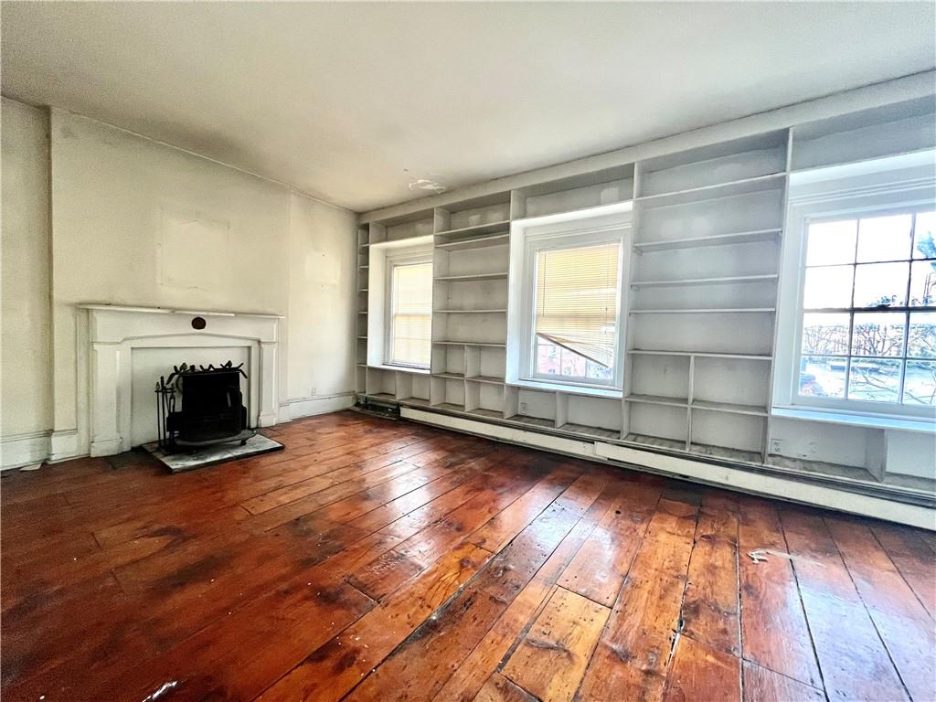 159 Bond Street Brooklyn, NY 11217 - Photo 18 of 20 a view of empty room with wooden floor and fireplace