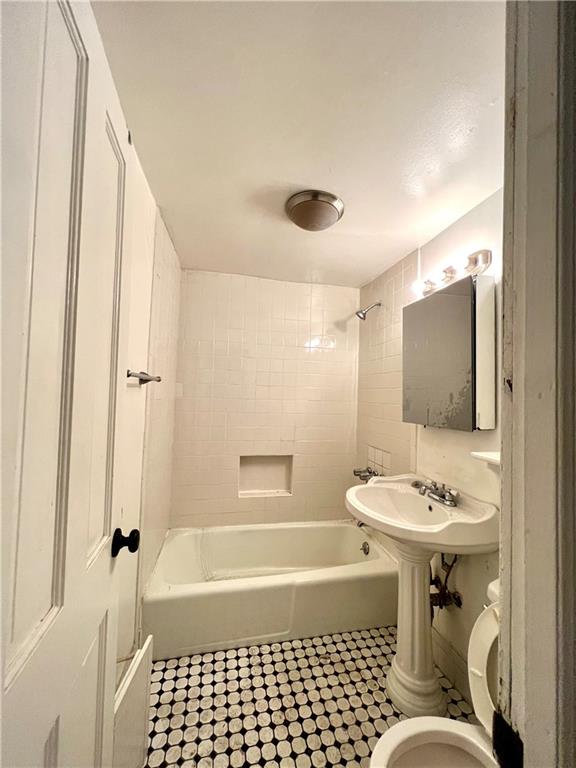 159 Bond Street Brooklyn, NY 11217 - Photo 19 of 20 a bathroom with a sink a mirror and a bathtub