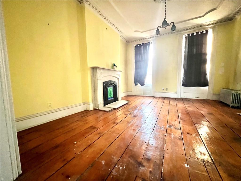 159 Bond Street Brooklyn, NY 11217 - Photo 9 of 20 a view of empty room with wooden floor and fan