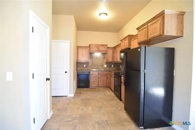 a kitchen with stainless steel appliances a refrigerator and a sink