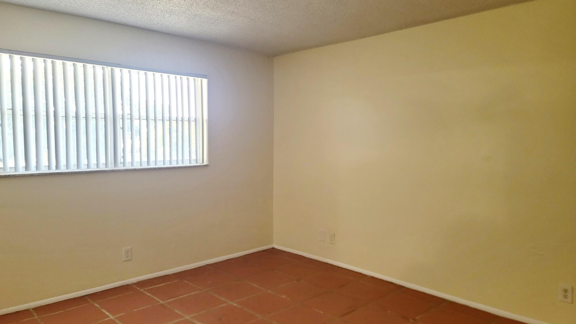 7911 North Colony Circle, Unit 305 Tamarac, FL 33321 - Photo 24 of 42 an empty room with a window