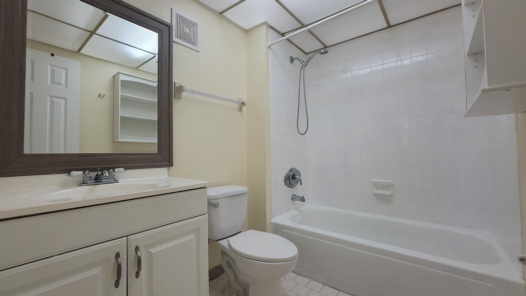 7911 North Colony Circle, Unit 305 Tamarac, FL 33321 - Photo 29 of 42 a bathroom with a sink toilet vanity and shower