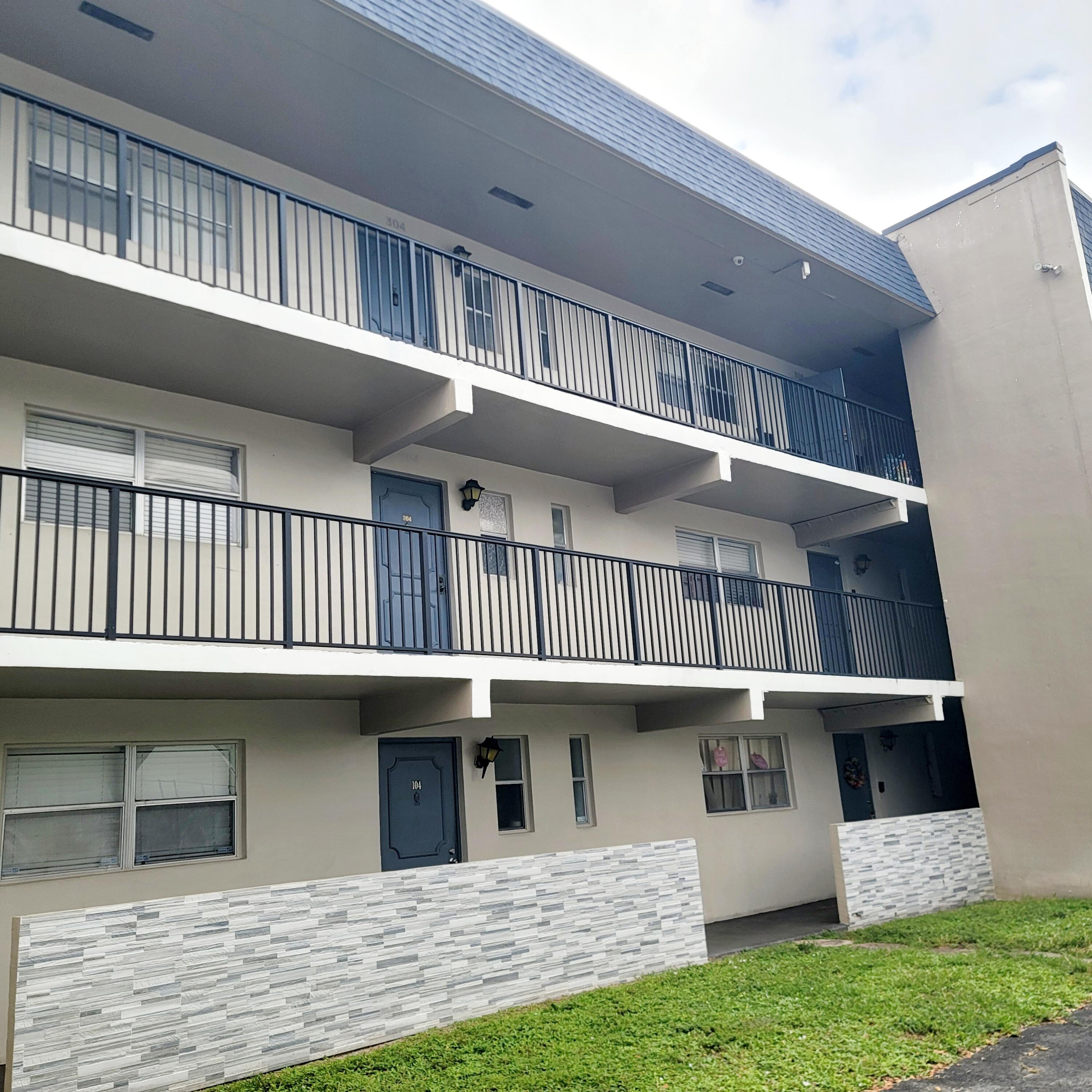 7911 North Colony Circle, Unit 305 Tamarac, FL 33321 - Photo 3 of 42 a view of a house with a deck