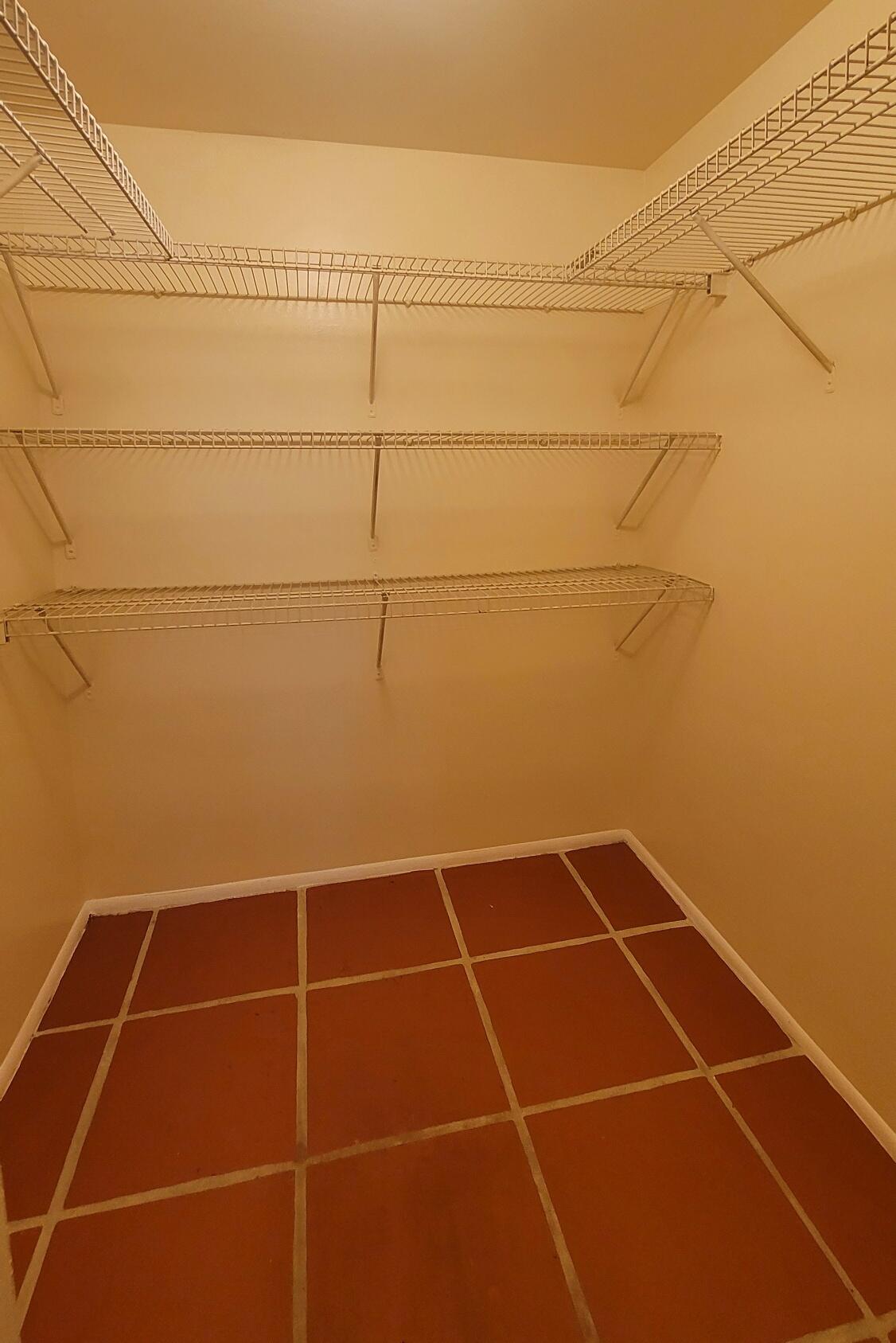 7911 North Colony Circle, Unit 305 Tamarac, FL 33321 - Photo 32 of 42 a bathroom with a white toilet and a sink