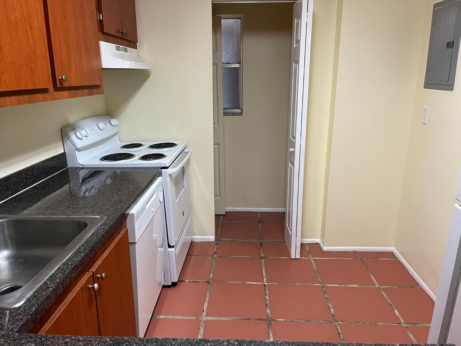 7911 North Colony Circle, Unit 305 Tamarac, FL 33321 - Photo 10 of 42 a kitchen with a stove and a refrigerator