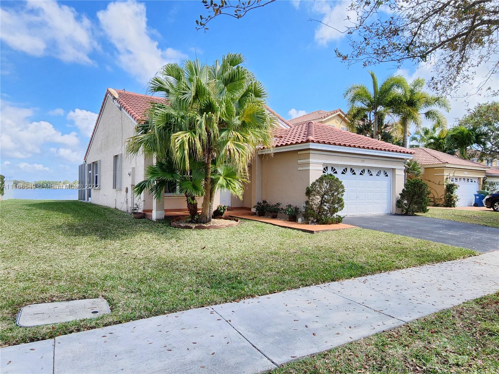790 Falling Water Road Weston, FL 33326 - Photo 3 of 34 a view of a house with a yard
