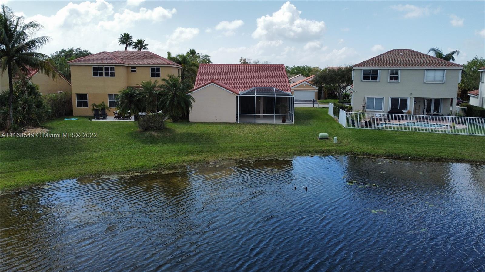 790 Falling Water Road Weston, FL 33326 - Photo 8 of 34 a front view of a house with a yard