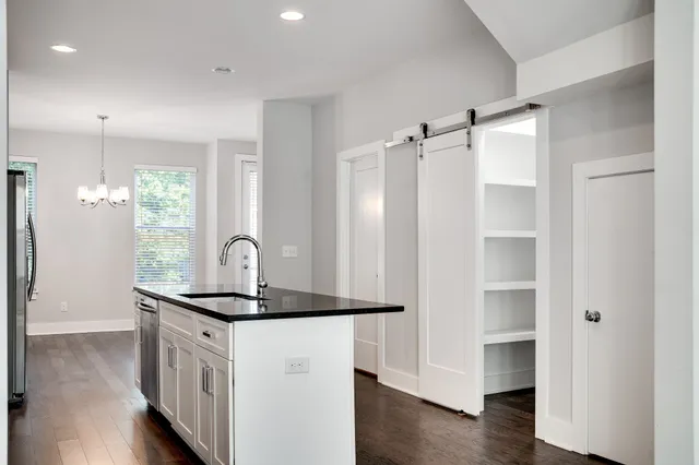 a kitchen with stainless steel appliances granite countertop a refrigerator and a sink