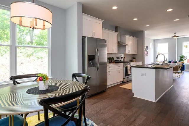 a dining room with furniture window and wooden floor