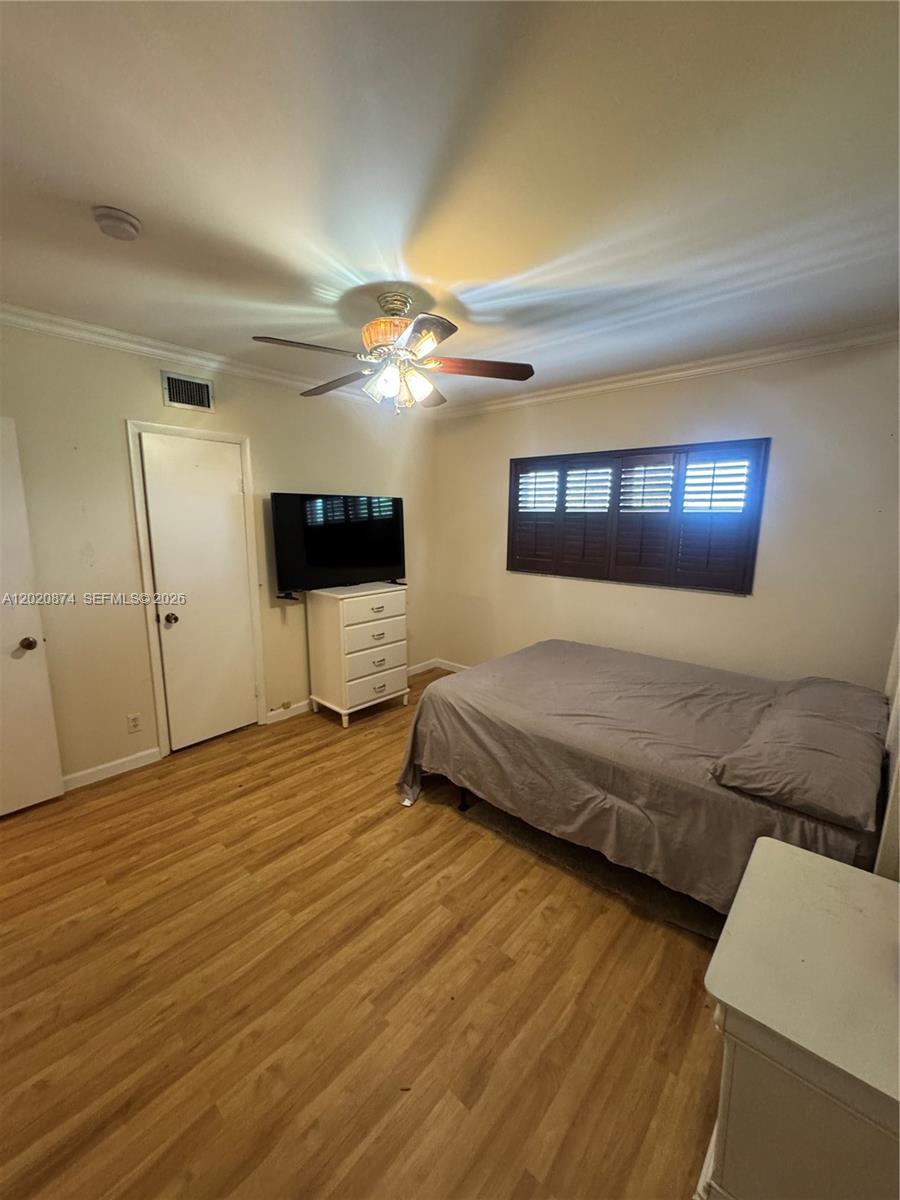 6731 Cypress Road, Unit 410 Plantation, FL 33317 - Photo 5 of 15 a bedroom with a bed and a chandelier