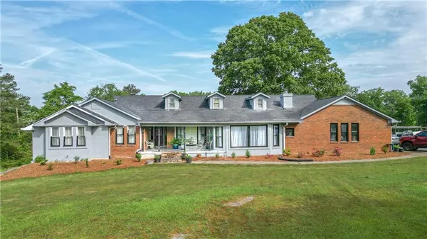 a front view of house with yard and green space