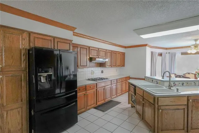 a kitchen with a stove and white cabinets
