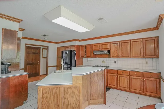 a kitchen with a sink window and cabinets