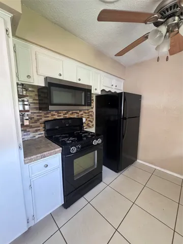a kitchen with stainless steel appliances a stove a microwave and a refrigerator
