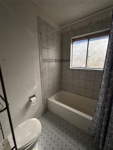 a bath tub sitting next to a toilet
