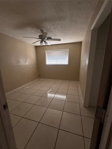 a view of a livingroom with a ceiling fan and window